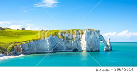 Picturesque panoramic landscape on the cliffs of Etretat. Natural amazing cliffs. Etretat, Normandy, France, La Manche or English Channel. Coast of the Pays de Caux area in sunny summer day. France 59645614