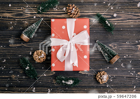 Christmas holiday composition with red gift box and tag decoration on wooden background Christmas holiday composition with red gift box and tag decoration on wooden background 59647206