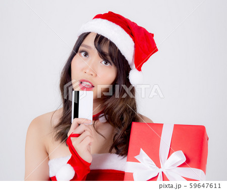 Beautiful portrait young asian woman happy holding credit card and red gift box in Christmas holiday 59647611