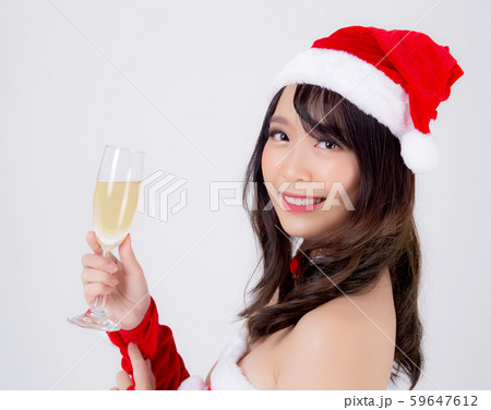 Beautiful portrait young asian woman in Santa holding glass of champagne with party celebrating 59647612