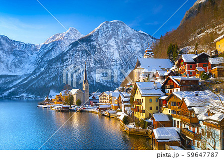 Classic postcard view of famous Hallstatt lakeside town in the Alps with traditional passenger ship on a beautiful cold sunny day with blue sky and clouds in winter, Salzkammergut region, Austria Classic postcard view of famous Hallstatt lakeside town in the Alps with traditional passenger ship on a beautiful cold sunny day with blue sky and clouds in winter, Salzkammergut region, Austria 59647787