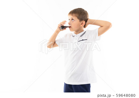 A little blonde boy drinks cola, picture isolated on white background 59648080