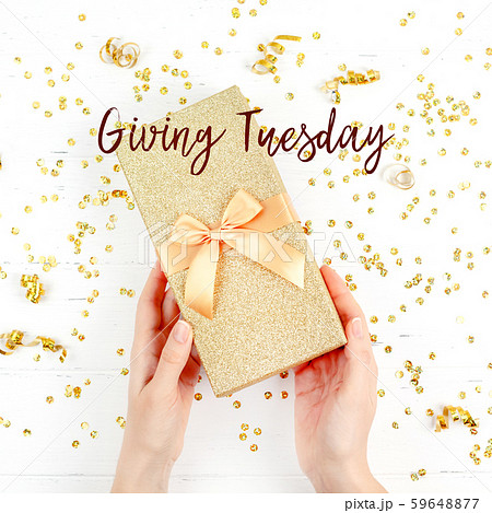 Giving Tuesday concept with golden box in hands 59648877