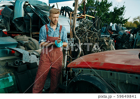 Male repairman with towel on car junkyard Male repairman with towel on car junkyard 59649841