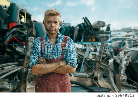 Dirty male repairman on car junkyard 59649913