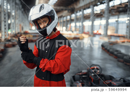 Kart racer in red uniform, helmet and gloves Kart racer in red uniform, helmet and gloves 59649994