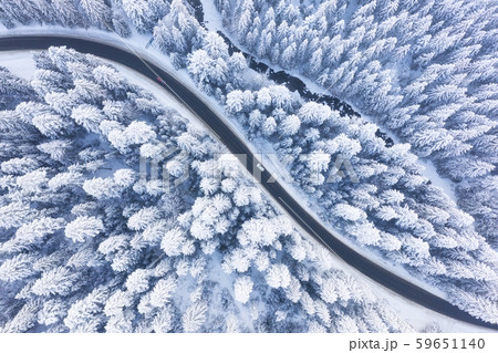 Aerial view on the road and forest at the winter time. Natural winter landscape from air. Aerial view on the road and forest at the winter time. Natural winter landscape from air. 59651140