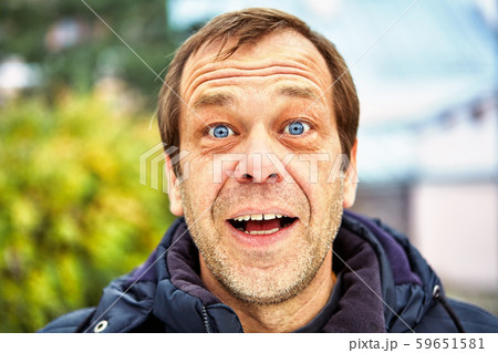 Street photo of a surprised middle-aged man. 59651581