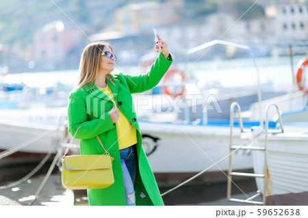 Beautiful woman tourist near the yacht during the journey, calls his travel agent 59652638