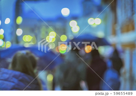Bokeh city lights, night. Abstract blurred people under the umbrellas. Rainy evening in the city 59655489