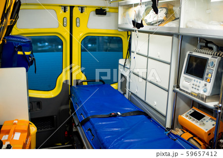 Interior of ambulance car with stretcher, refrigerator and medical equipment Interior of ambulance car with stretcher, refrigerator and medical equipment 59657412