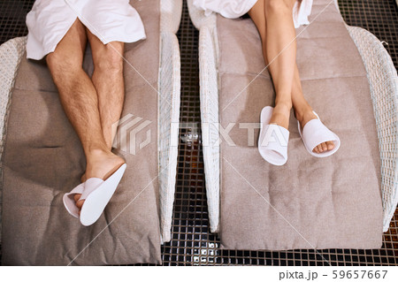 Legs of people wearing slippers 59657667