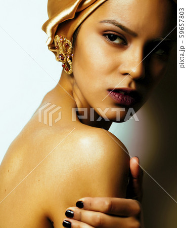 beauty african woman in shawl on head, very elegant look with gold jewelry close up mulatto makeup beauty african woman in shawl on head, very elegant look with gold jewelry close up mulatto makeup 59657803