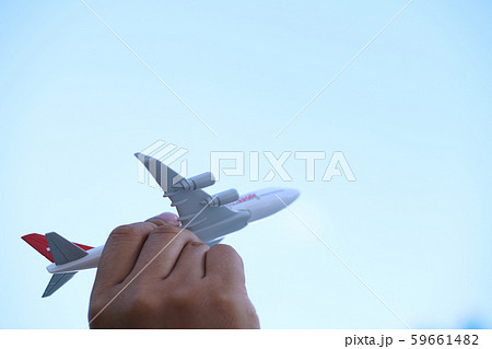Young asian holding miniature toy airplane flying Young asian holding miniature toy airplane flying 59661482