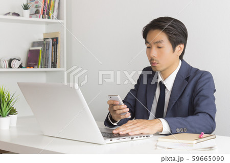 Asian Financial Advisor or Asian Consulting Businessman Sending Message or Chat 59665090