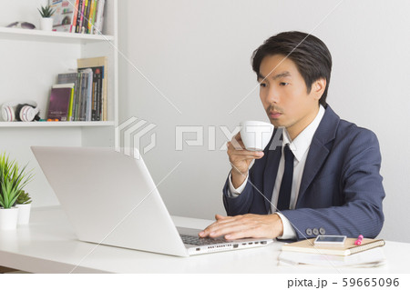 Asian Financial Advisor or Asian Consulting Businessman Drinking Coffee Asian Financial Advisor or Asian Consulting Businessman Drinking Coffee 59665096