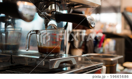 Coffee in measuring cup on a coffee machine Coffee in measuring cup on a coffee machine 59665686