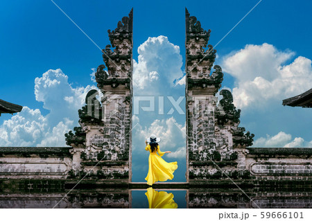 Young woman standing in temple gates Young woman standing in temple gates 59666101