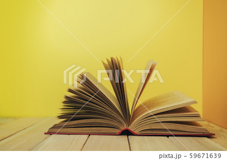 Beautiful book on a wooden table and yellow orange Beautiful book on a wooden table and yellow orange 59671639