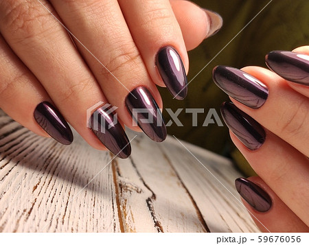 Gray striped nail design on female hand close up. Gray striped nail design on female hand close up. 59676056