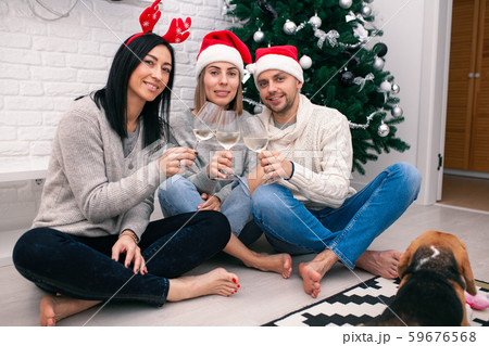 Happy friends celebrating New Year in home Happy friends celebrating New Year in home 59676568