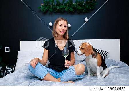 Young beautiful woman playing with dog sitting on Young beautiful woman playing with dog sitting on 59676672