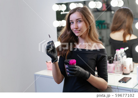 Beautiful young Caucasian makeup artist standing 59677102