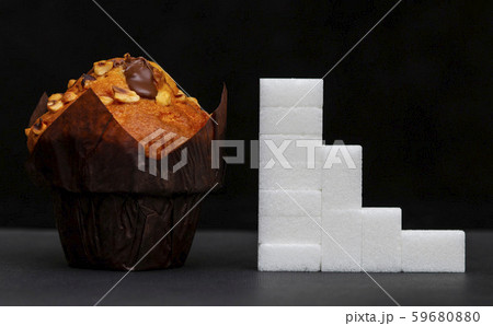 sugar level next to the cupcake, cubes sugar 59680880