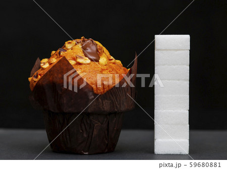 sugar level next to the cupcake, cubes sugar 59680881
