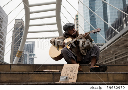 Old beggar play music for money Old beggar play music for money 59680970
