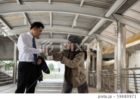 Kind businessman give money to beggar Kind businessman give money to beggar 59680971