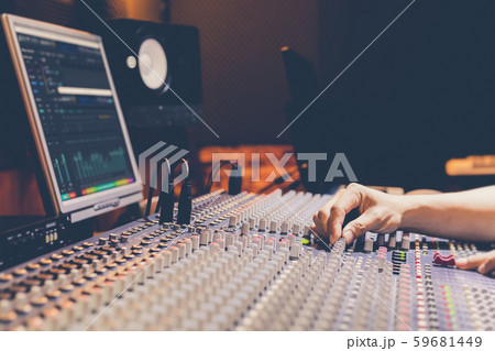 male producer, sound engineer hands working on audio mixing console in broadcasting, recording studio male producer, sound engineer hands working on audio mixing console in broadcasting, recording studio 59681449
