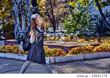 Girl teenager schoolgirl in a school uniform walks Girl teenager schoolgirl in a school uniform walks 59681778