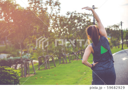 Women exercising. Young fitness woman exercising in the morning at the public park. Women exercising. Young fitness woman exercising in the morning at the public park. 59682929