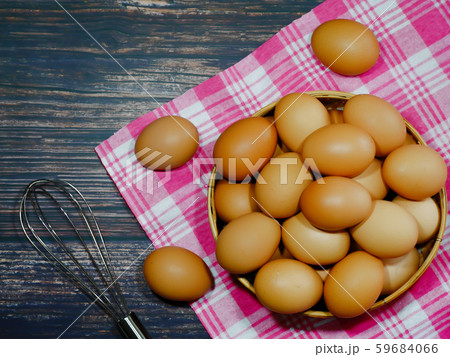 the eggs in a basket place on pink fabric on a black background the eggs in a basket place on pink fabric on a black background 59684066