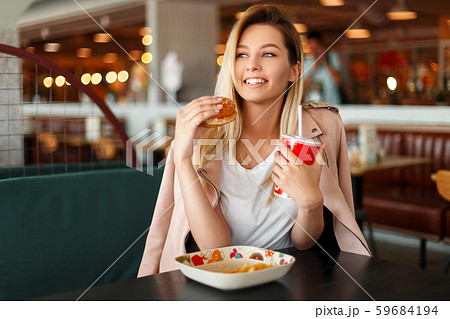 Satisfied beautiful young woman with a smile Satisfied beautiful young woman with a smile 59684194