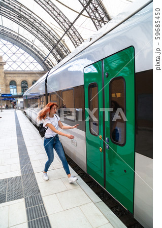 Girl runs on platform to door of departing train Girl runs on platform to door of departing train 59685450