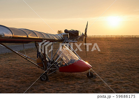 Ultralight single-engine single-seat aircraft stands on the airfield in the early morning 59686175