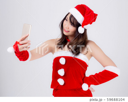 Beautiful portrait young asian woman in Santa cheerful taking a photo in Christmas holiday isolated Beautiful portrait young asian woman in Santa cheerful taking a photo in Christmas holiday isolated 59688104