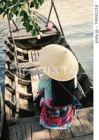Woman sitting on the wooden boat 59692258