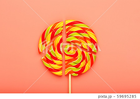 Lollipop broken into pieces on pink background, Lollipop broken into pieces on pink background, 59695285