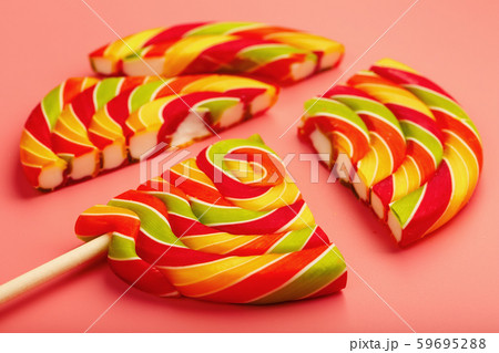 Lollipop broken into pieces on pink background, 59695288