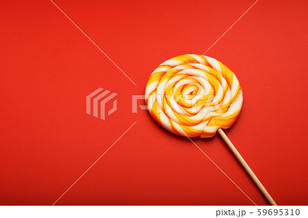 Colorful round Lollipop, on red background. Colorful round Lollipop, on red background. 59695310