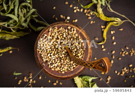 Cannabis seeds and marijuana leaves in a bowl on Cannabis seeds and marijuana leaves in a bowl on 59695843