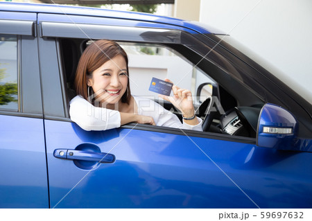 Happy young Asian woman holding payment card Happy young Asian woman holding payment card 59697632