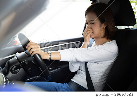 Young Asian woman hold her nose because of bad Young Asian woman hold her nose because of bad 59697633