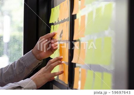 IT worker tracking his tasks on kanban board. IT worker tracking his tasks on kanban board. 59697643