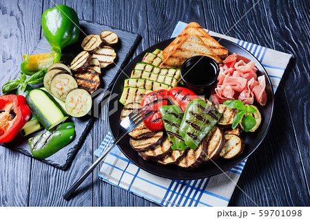 grilled vegetables, ham, toasted bread on a plate grilled vegetables, ham, toasted bread on a plate 59701098