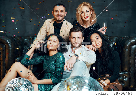 Diverse group of happy young friends having fun enjoying party and drinking champagne Diverse group of happy young friends having fun enjoying party and drinking champagne 59706469