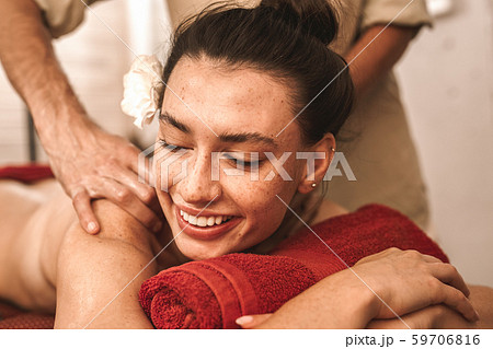Alternative Medicine. Therapist healing woman laughing cheerful close-up doing abhyanga back massage Alternative Medicine. Therapist healing woman laughing cheerful close-up doing abhyanga back massage 59706816